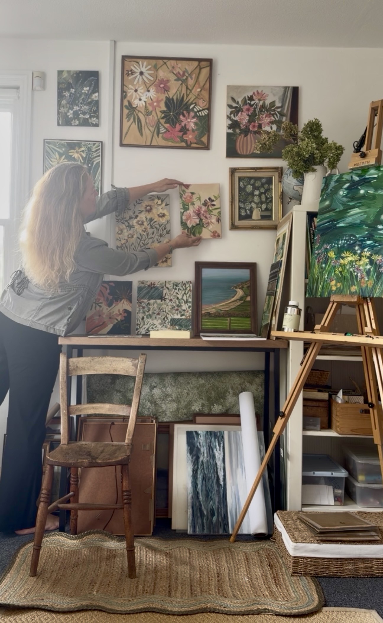Sarah Watkinson arranging paintings in her Guildford studio